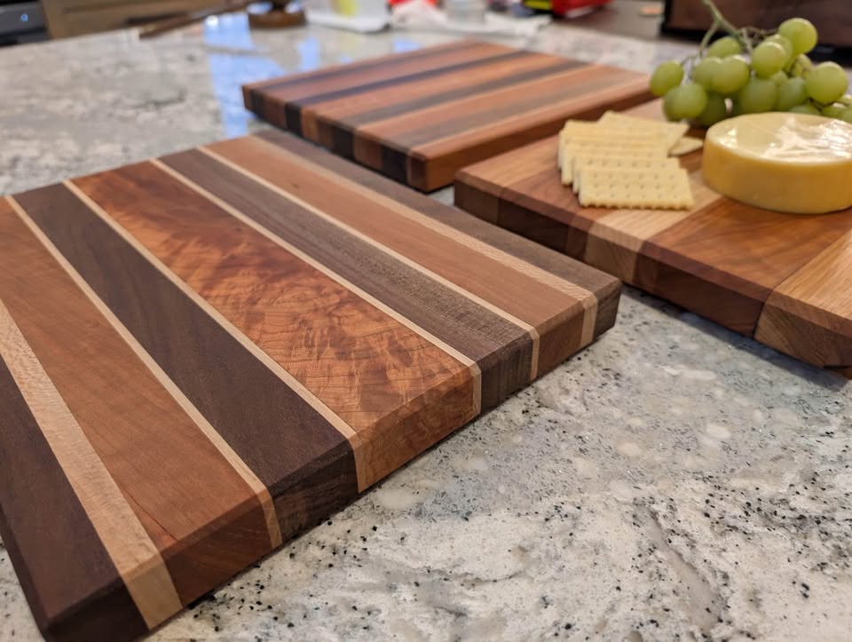 Collection of handcrafted striped cutting boards arranged with food